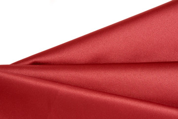 folds of glossy red satin fabric. Background or texture