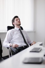 tired and depresed young business man at office