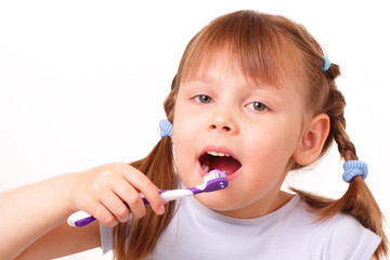 Beautiful little girl brushes her teeth