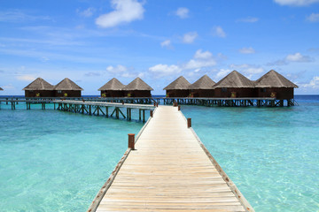 Long wooden bridge and water villas,Maldives