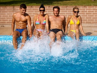 Young people having summer fun by pool