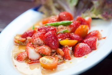 Strawberries spicy salad with chili, tomatoes and vegetables