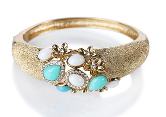 Beautiful golden bracelet with precious stones isolated on