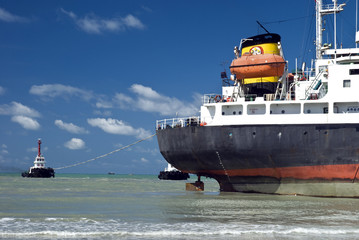 Cargo ship run aground on rocky shore