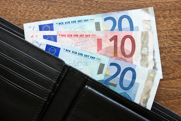 wallet with euros on the table