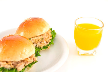 Two Fresh burger with tuna on plate and Orange juice