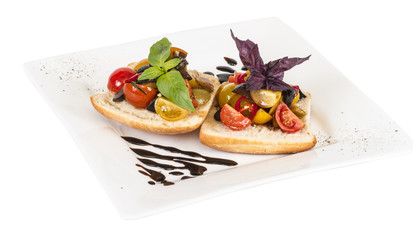 juicy tomatoes on fresh bread, pesto as topping