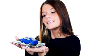 The beautiful woman with money and toy car in hands