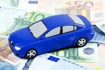 The toy car for euro banknotes as a background