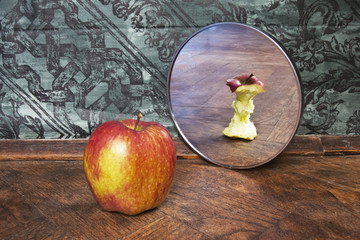 surrealistic picture of an apple reflecting in the mirror