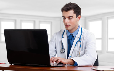 Doctor working on his computer