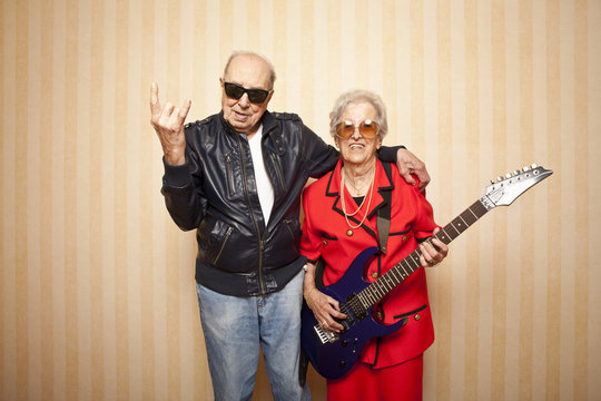 cool fashion elder couple with electric guitar