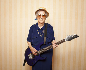 cool fashion elder lady with electric guitar