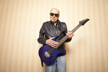 cool fashion elder man with electric guitar