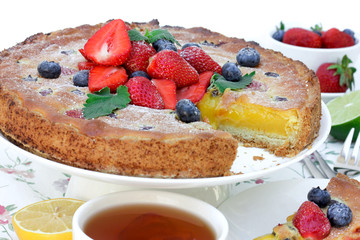 A cake with citrus cream and fresh berries