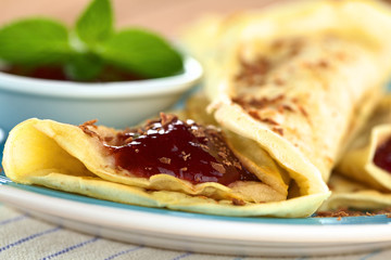 Fresh homemade crepe filled with strawberry jam