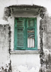 Old green woody window on Moldy wall