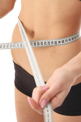 A woman measuring her waist