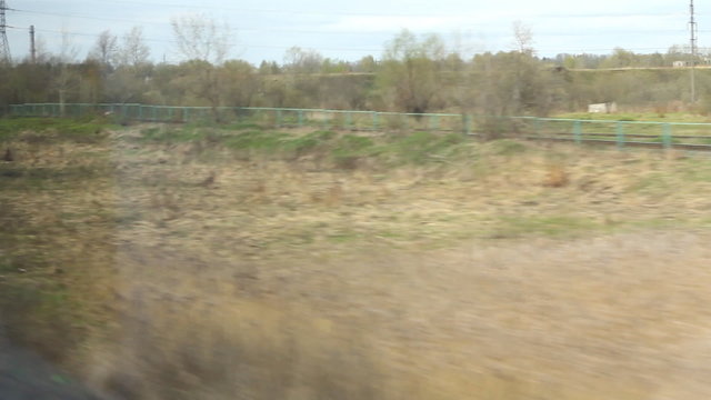 View from high-speed train window on the fields in spring