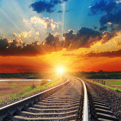 dramatic sunset over railroad