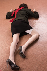 Business woman lying on the floor. Crime scene simulation