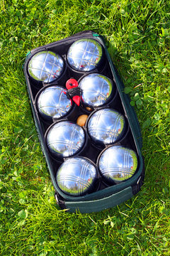 The bocce balls on a green grass.