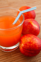 fresh juice in a glass and peaches