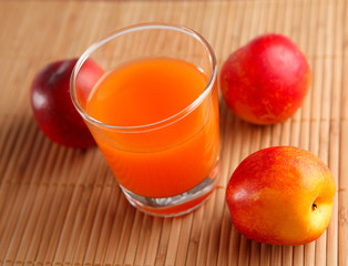 fresh juice in a glass and peaches