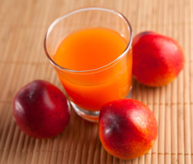 fresh juice in a glass and peaches