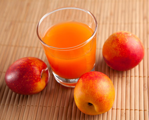 fresh juice in a glass and peaches