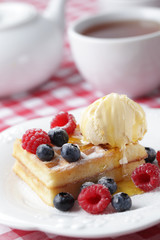 Waffles with berries and ice cream