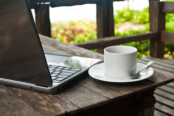 Coffee cup and laptop for business.