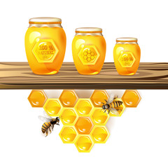 Glass jar and honey over piece of wood