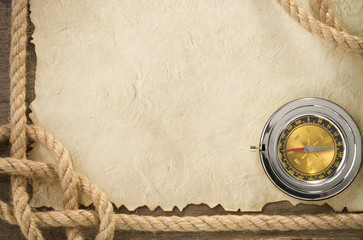 ropes and compass at old vintage ancient paper