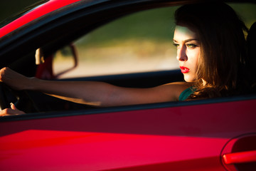 woman in red car