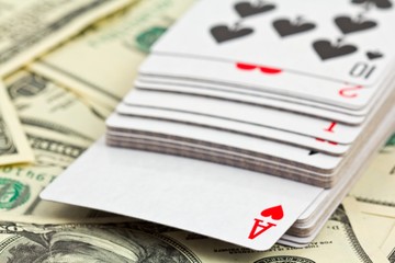 Fototapeta na wymiar playing cards on a money background