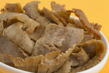 Donner Meat - Slices of Donner/Gyro Meat on a yellow background