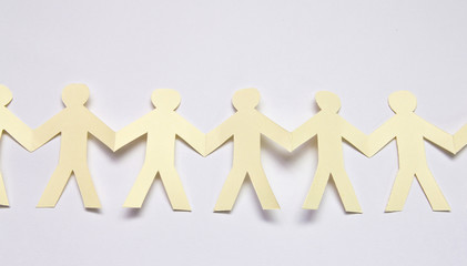 Cutout paper people over white background