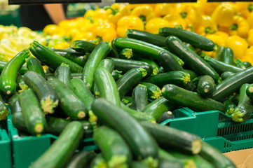 Bunch of zucchini on boxes in supermarket