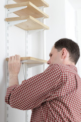 Man installing shelves