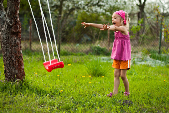 Happy girl is playing with swing.