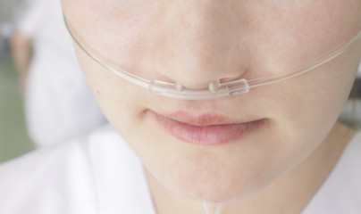 Breathing through a plastic nasal catheter during illness - obrazy, fototapety, plakaty