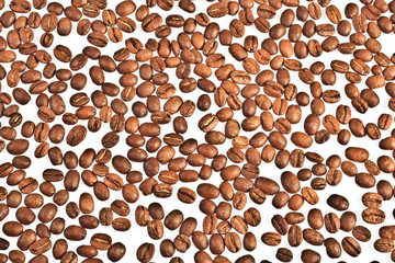 Spilled coffee beans on a light background.