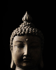 Buddha close up on black background