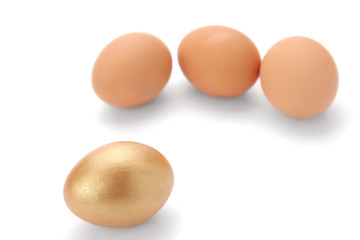 A golden egg near usual ones