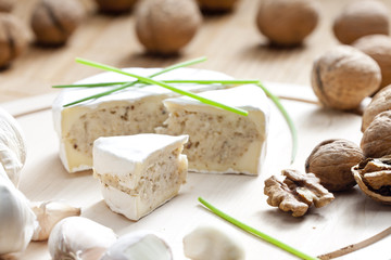 cheese brie filled with cheese mixture of chopped walnuts and ga