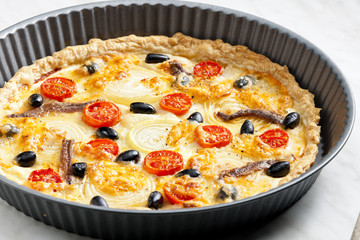 cake with anchovies, cherry tomatoes and black olives