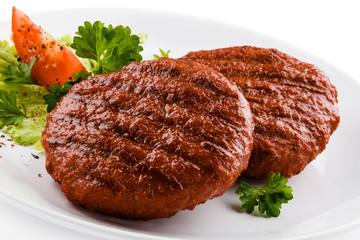 Grilled beefsteaks and vegetables