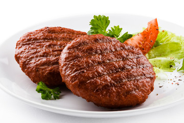 Grilled beefsteaks and vegetables