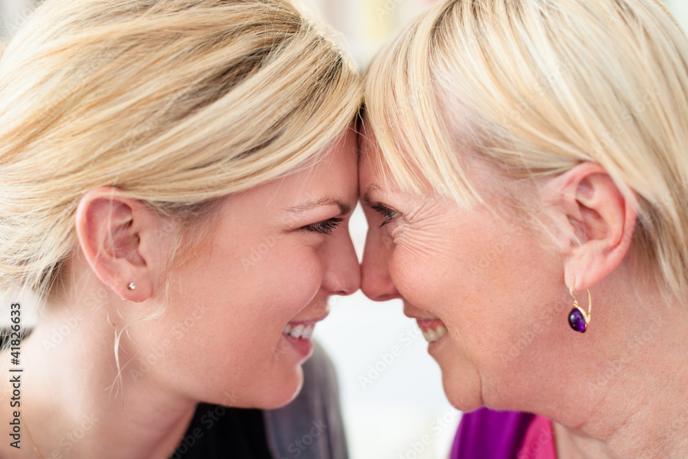 Wall mural mother and daughter looking at each other